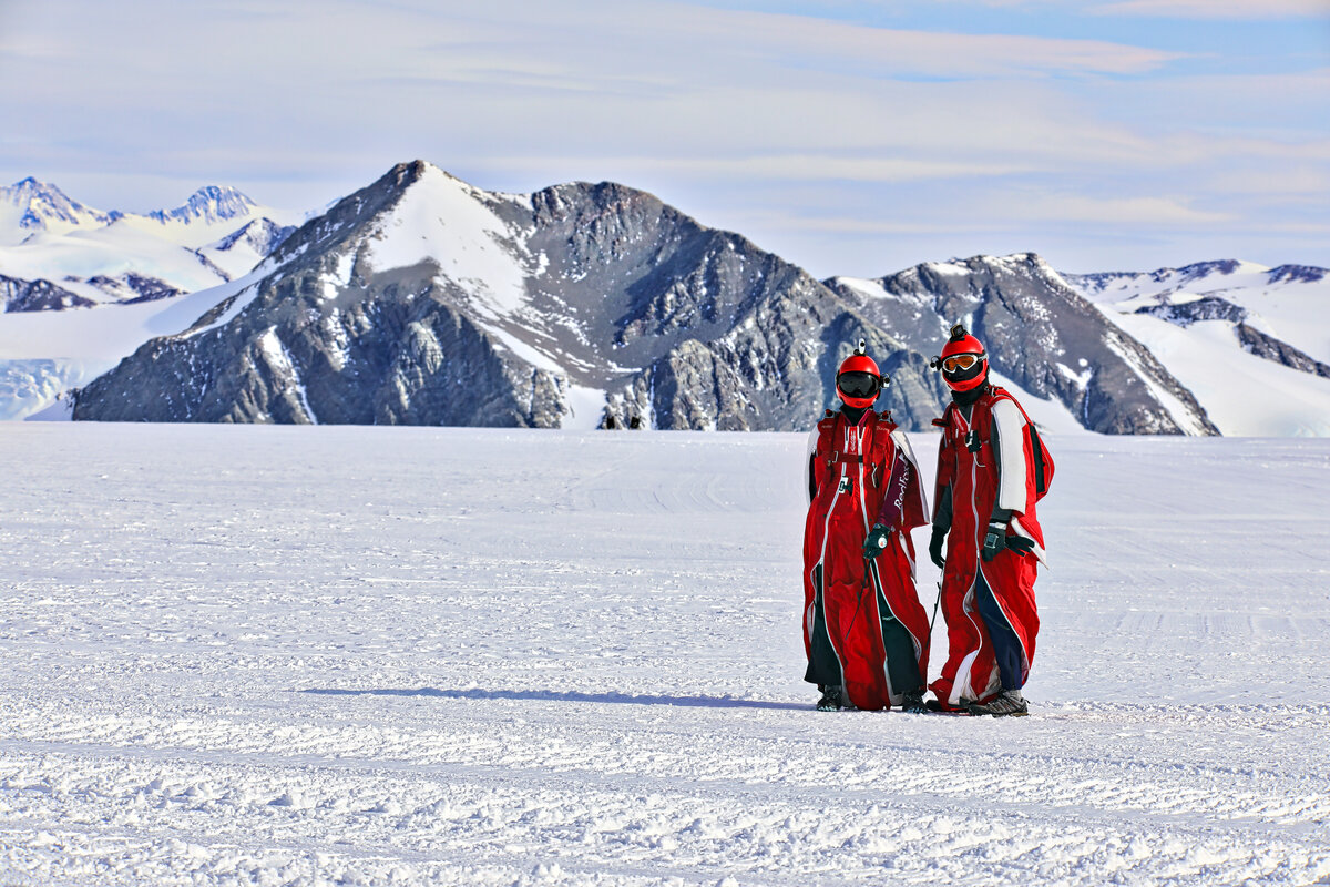 Wingsuiters wait on the skiway before boarding a Twin Otter
