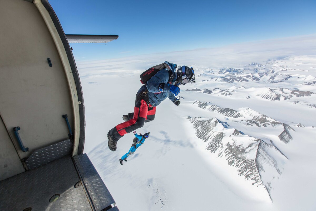 Divers exit a Twin Otter over Union Glacier