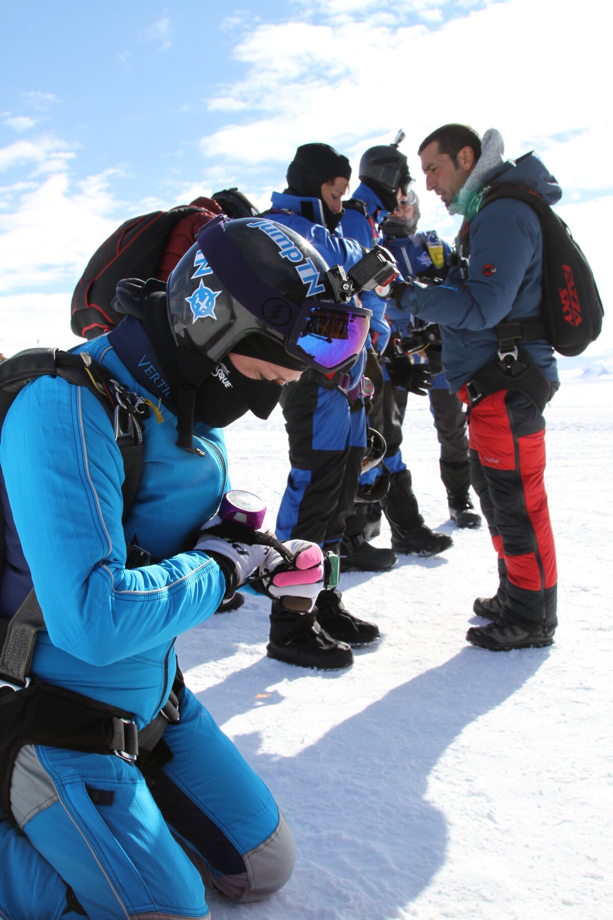 Skydivers check their equipment